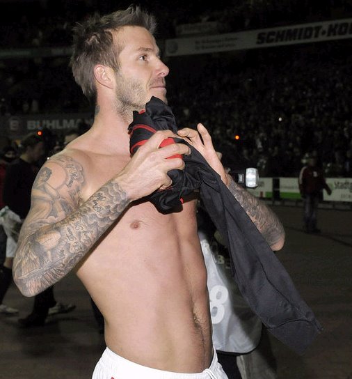 art soccer tattoo David Beckham with tribal tattoo on his arm, beckham is an English soccer player. art soccer tattoo David Beckham with tribal tattoo on