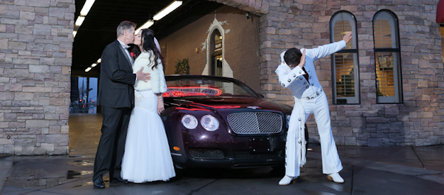 Las Vegas high roller couple exchange a kiss with Elvis as their minister at the Vegas Weddings Fast Lane drive thru wedding venue.