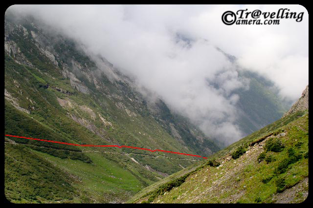 Typical Trekking routes on the way to Manimahesh Yatra in Himlayas (Pir Panjal Mountain ranges) : Part-2 : Posted by VISHAL SHARMA on www.travellingcamera.com : Continuing the PHOTO JOURNEY through various treks to Manimahesh, here are few more photographs on the way to Manimahesh Pilgrimage Yatra in Chamba District of Himachal Pradesh...Check out Part-1 if you have missed itNow clouds have starting chasing us and it can be a bad sign for such treks... Since trees will not be there on these heights, there will be no space to escape if rains start... If there is no rain, journey becomes wonderful with these clouds... because you will never know how much you have to cover next :-)Some of us had some tents so we were comparitively safe if rain would have started... Here is a again a view of valley in the bottom of two hills with tents... Many of the pilgrims were looking back after some time... clouds were becoming more dense as we moved ahead...Other worry was the path... since it was soil and stones... after rains it becomes risky to walk over them... If you are first time trekkking on hills, its important to have nice shoes with appropriate grip and have to have pateince to walk on the a balanced pace to avoid any mishappening... Don't worry, I was getting more sensitive about it.. Plan better and its very easy :-)Here is an amazing this... See this path started form hill on right side and moved towards the another hill on left which is just opposite to the first one... But everyone had to cross through the same route, because the riverlets you see in the middle had very fast current... which is not very clear in this photographs.. but if  you compare the size of tents and width of this strea, you would be able to estimate it... This whole path  from one hill to another was around 4-6 kms....Here comes the next level of tis trek with more rocky hills around and less grass.. Indicating that oxygen level is going down now.... Check out the photograph above and try to find out the path we followed.. Similarly, in this photograph its not very easy to locate the path... One is short cut and other one is long but smooth... Imagine yourself on this trek and huge moutains around... Can you see a large group of pilgrims on the turn?? Imagine the size of these hills... I can't explain...Pilgrims taking rest on the way to Manimahesh Lake in Bharmour region of Chamba District in Himachal Pradesh...People who can't walk upto the hills and don't want to ride in Helicopter have another option... Horse Riding  @ Mani Mahesh, Chamba, Himachal Pradesh, INDIA