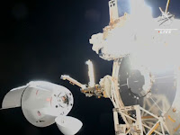 SpaceX Dragon cargo ship arrives at space station with NASA supplies.