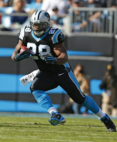 Carolina Panthers' Jonathan Stewart (28) runs as Denver Broncos' Mike Adams (20) pursues during the first quarter of an NFL football game in Charlotte, N.C., Sunday, Nov. 11, 2012. (AP Photo/Bob Leverone)