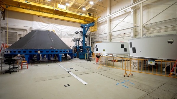 At NASA's Marshall Space Flight Center in Huntsville, Alabama, a test version of the payload adapter that will be used on the Space Launch System's (SLS) Block 1B rocket is displayed next to the Orion stage adapters that will fly on the Artemis 2 and 3 missions, respectively.
