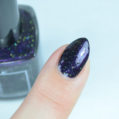 purple shimmer nail polish with green glitter