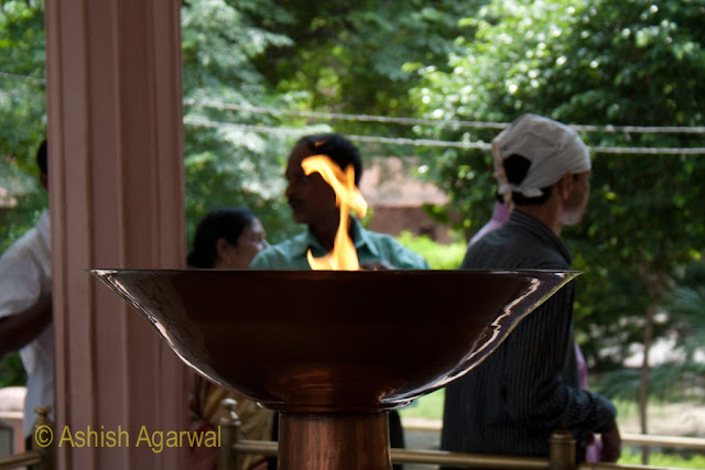 The ceremonial flame at the Jallianwala Bagh at Amritsar with people in the background