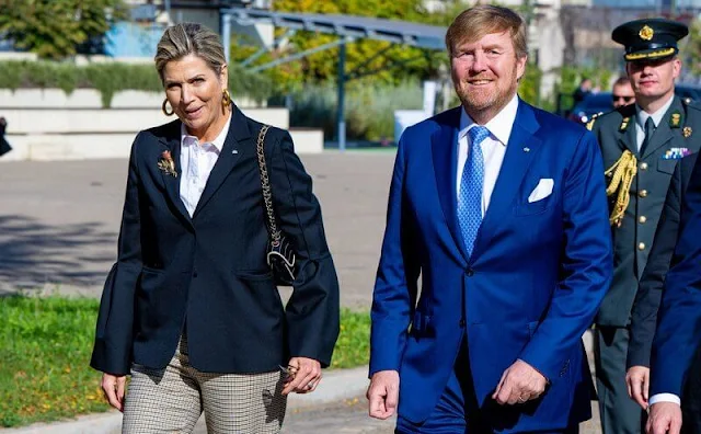 Queen Maxima wore a new navy blue structured shoulder bell sleeve blazer, and trousers. Gold brooch