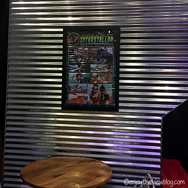 corrugated aluminum wall with an alien comic poster