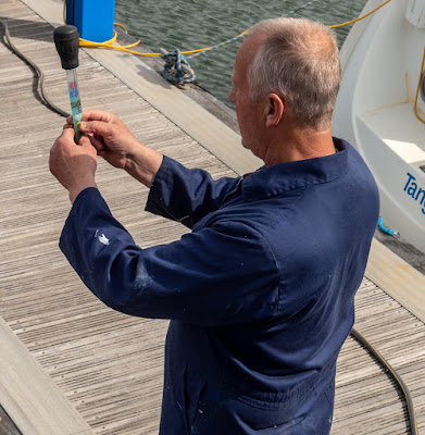 Photo of Phil checking the antifreeze/water mixture with a hydrometer