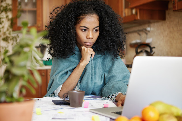 Image of Beautiful black woman sitting in front of her computer.