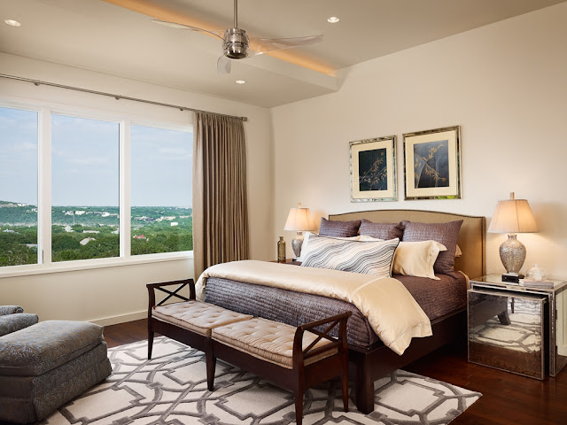 Photo of king sized bed in the bedroom of modern house on the hill