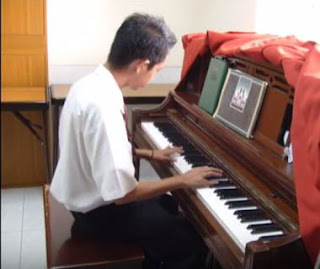 Gilbor Jr. playing the piano