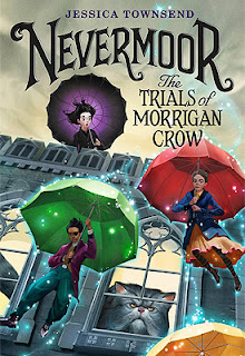 Book cover, 'Nevermoor: The Trials of Morrigan Crow.' Image depicts several people floating down from a rooftop, each holding a colorful umbrella that emits a sparkling substance. A young girl with black hair, wearing a black dress, and holding a black umbrella, stands above them on the roof-top watching them, a surprised look on her face. A giant gray cat with a squashed face, and grumpy-looking expression, stares from inside the building, out the window at the goings-on