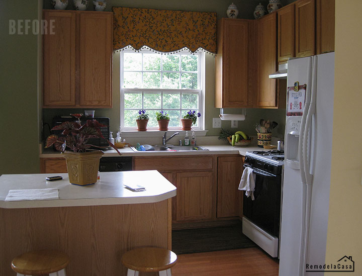 A 90's kitchen with oak cabinets and white appliances - before.