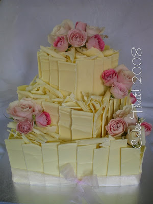 a pale dusty pink rose to decorate this three tier cake This Wedding is