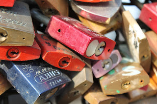 Padlocks with messages of love locked to bridge