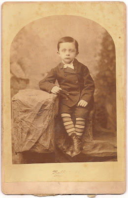 Tully family Hull artist Chicago striped socks young boy seated