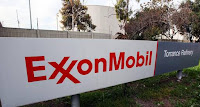 This Jan. 30, 2012, file photo shows the sign for the Exxon Mobil Torrance Refinery in Torrance, Calif. Exxon Mobil held its annual shareholder meeting Wednesday, May 25, 2016, as it faces volatile crude prices and investigations into what it knew and allegedly didn't disclose about oil's role in climate change. (Credit: Associated Press) Click to Enlarge.