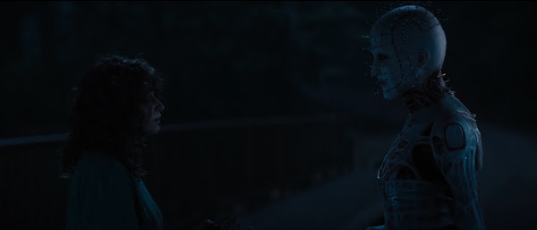 Pinhead urges Riley to continue solving the puzzle.