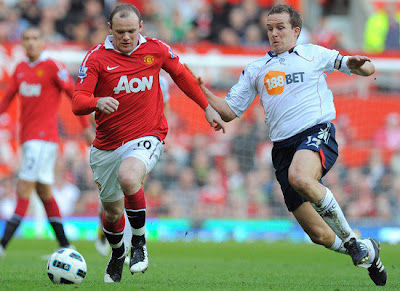 Wayne Rooney vies with Kevin Davies Barclays Premier League