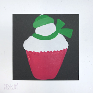 Snowman topped cupcake - with painted areas of red (the cupcake wrapper) and green (for the Snowmans hat and scarf)