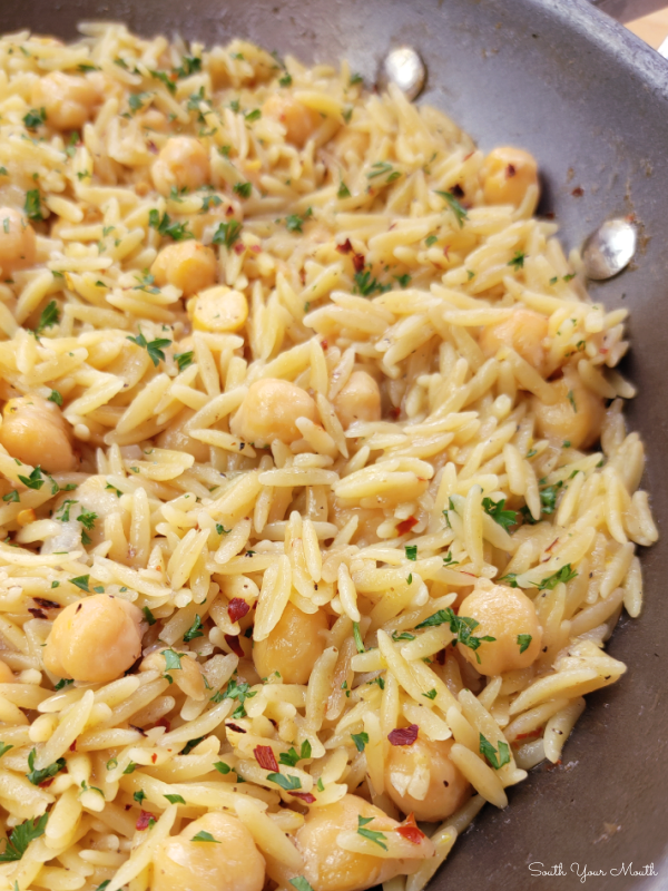 Spicy Chickpeas with Orzo! A Mediterranean inspired recipe with chickpeas (garbanzo beans), orzo and layers of spices and mild heat that doubles as the perfect side or a meatless main dish.