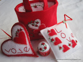 Felt loveheart ornament, square pillow, bottle cap pincushion and small felt bag decorated with red roses and lovehearts 