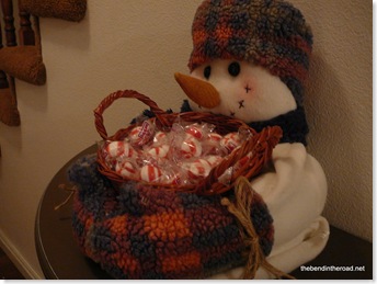 snowman offering treats to visitors