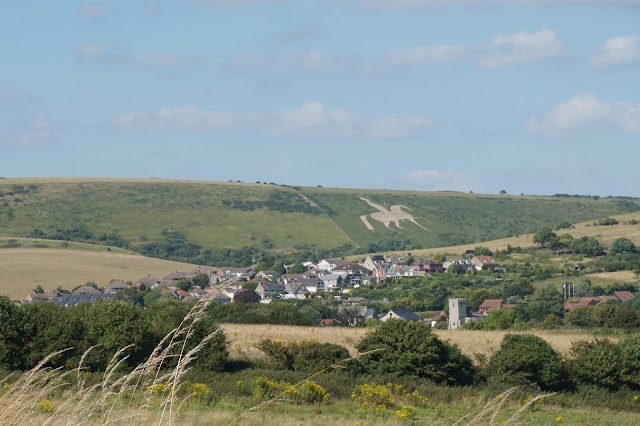 View towards a chalk white horse on a hill which is off George III riding in to Weymouth to take a swim in the local waters in a bathing machine