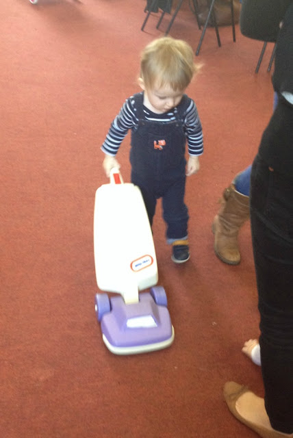 Toddler with toy Vacuum cleaner