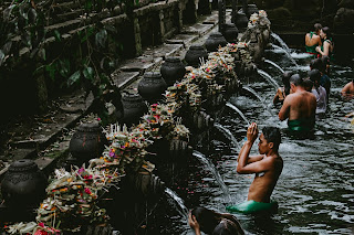 a man showering in a sacred temple in bali