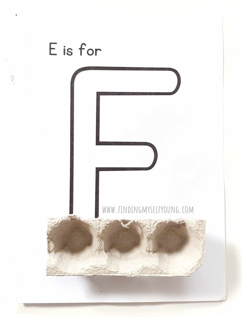 First piece of egg carton added to letter E.