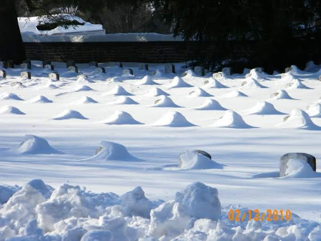 snow covered headstones