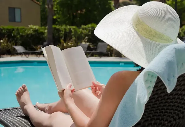 A woman reading a book and relaxing on a hotel in naxos