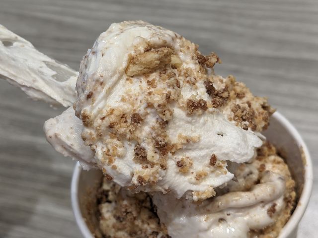 McDonald's Peanut Butter Crunch McFlurry close-up in a spoon.