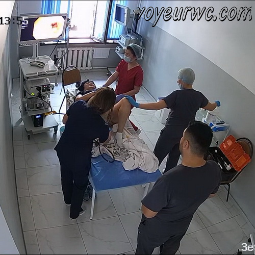 A patient lies on their side while a gastroenterologist inserts a colonoscope (Female colonoscopy SpyCam 32-35)
