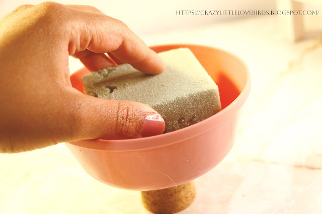 Hand inserting foam block into bowl