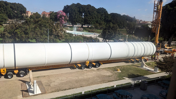 The first of Endeavour's two solid rocket motors is about to be lifted and placed onto a temporary workstand near the Rose Garden at Exposition Park...on October 11, 2023.