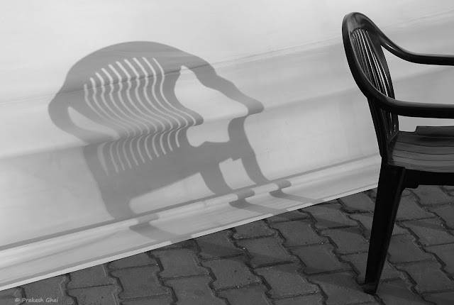 A Series of 3 Black and White Minimalist Photographs of a Plastic Chair and its shadow captured at Jawahar Kala Kendra, Jaipur, India.