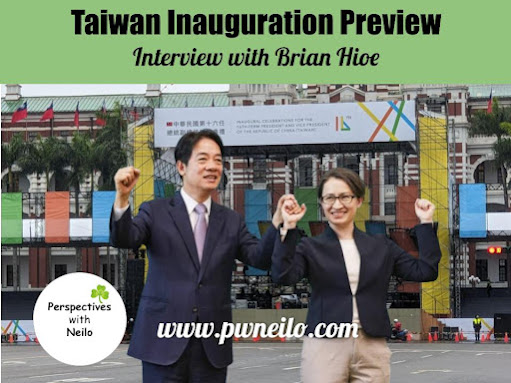 President elect Lai Ching-te and Vice President elect Hsiao Bi-khim hold hands in victory to the backdrop of the presidential office in Taipei