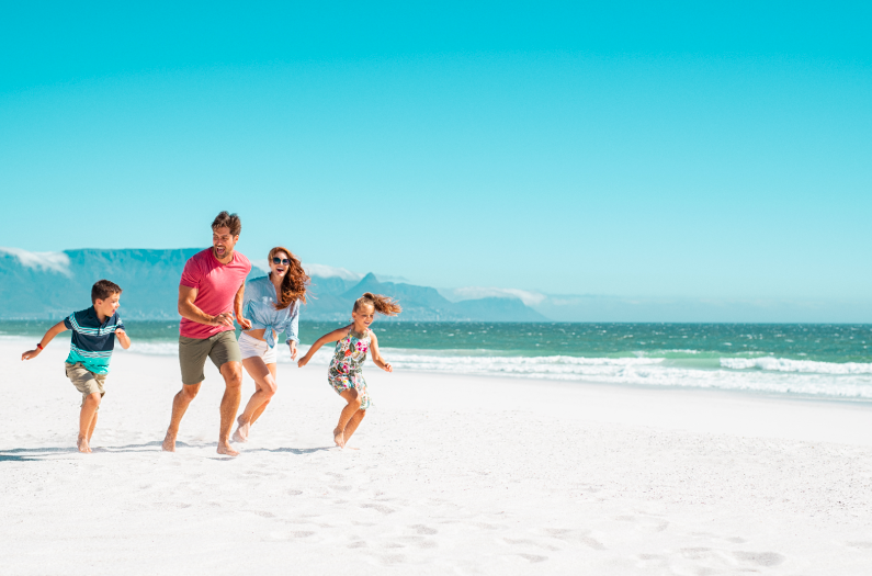 family running along a beach