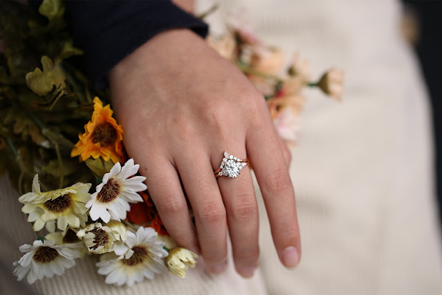A woman wearing a moissanite engagement ring