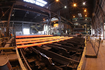 The inside of the Nucor Steel Warehouse. It is full of pipes and looks very industrial.