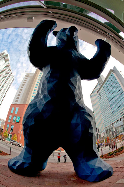 Two little boys standing under the Big Blue Bear in Denver.