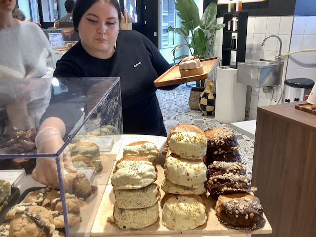 Saleswoman grabbing large chocolate chip cookies