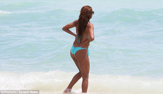 Bikini-clad Claudia Jordan enjoys the sand and surf with friend Aisha Thalia in Miami