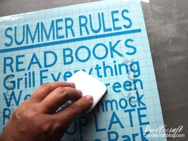 Place vinyl cut with Cricut Maker on wood board to make a Summer Rules Cricut Vinyl Wood Sign DIY