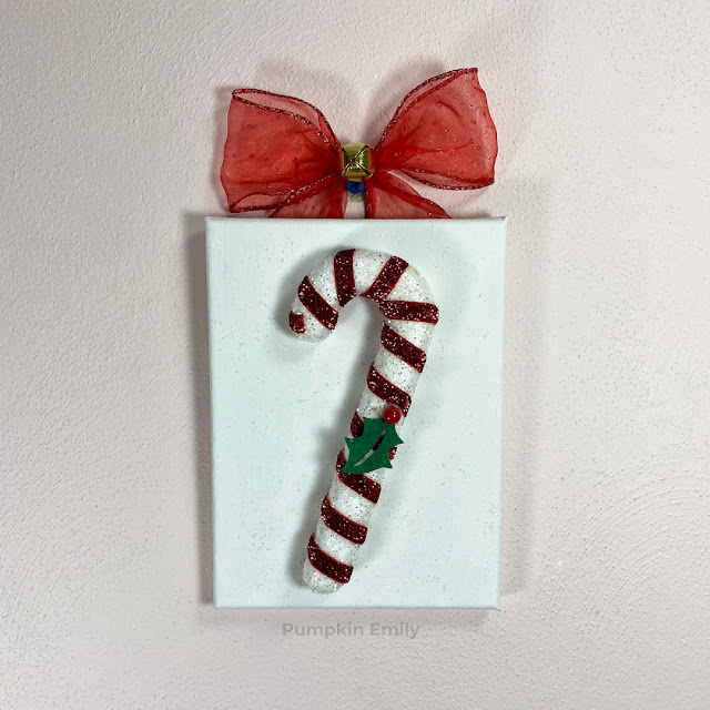 A white canvas with a ornament on it.