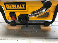 Setting 2X4 blocks under the saw's feet