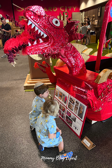 Young Boys CheckOut Giant Red Dragon Recyled Cardboard Sculpture Kids Art Museum