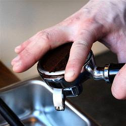 tamping espresso grounds