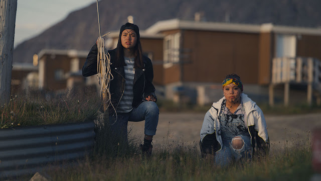 three Inuit girls in a small town